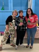 Della presenting gifts to outgoing Management Team members Delphine and Brittany